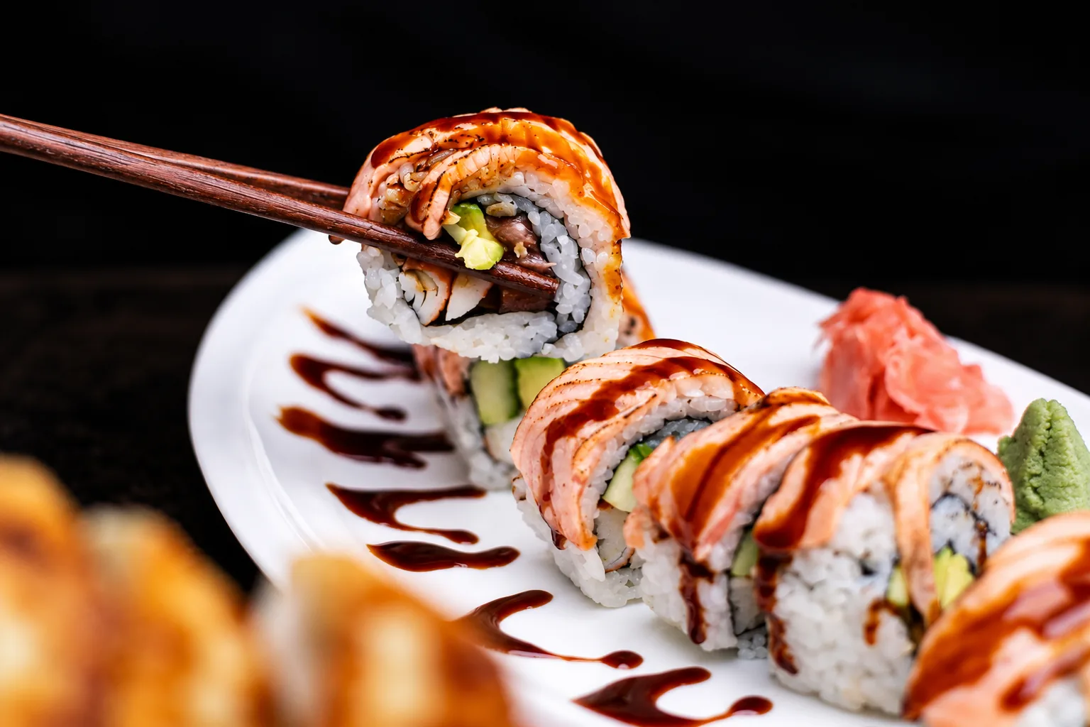 Salmon maki served with chopsticks on a white plate
